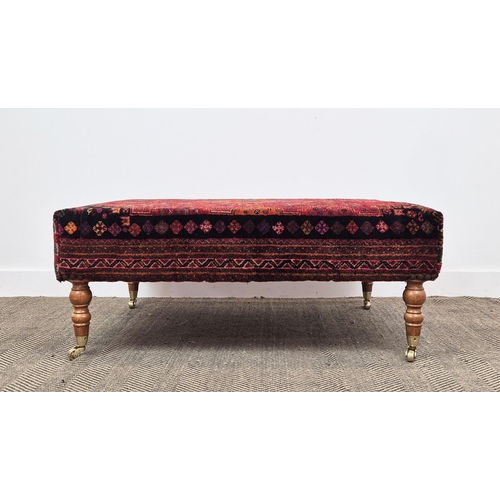 193 - HEARTH STOOL, rectangular red carpet upholstered on beech legs and brass castors, 43cm H x 105cm W x... 