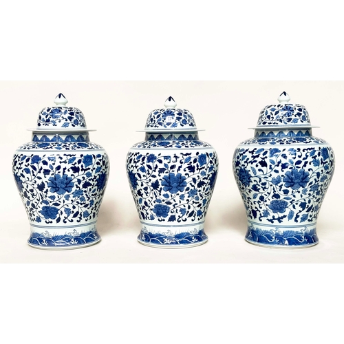 231 - TEMPLE JARS, a set of three, Chinese ceramic blue and white lotus leaf of ginger jar form with lids,... 