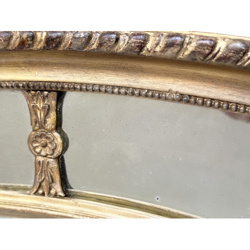 214 - WALL MIRROR, early 20th century George III design oval carved giltwood and gesso, moulded with bevel... 