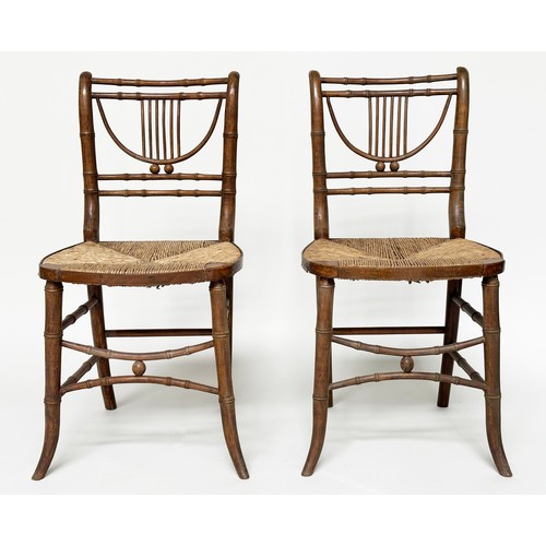 204 - SIDE CHAIRS, a pair, Regency faux bamboo each with lyre backs, woven rush seats and swept supports, ... 