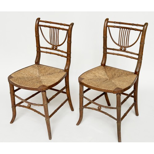 204 - SIDE CHAIRS, a pair, Regency faux bamboo each with lyre backs, woven rush seats and swept supports, ... 