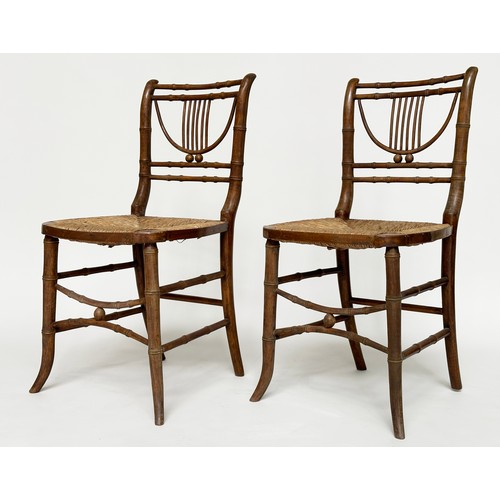 204 - SIDE CHAIRS, a pair, Regency faux bamboo each with lyre backs, woven rush seats and swept supports, ... 