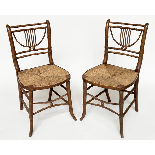 204 - SIDE CHAIRS, a pair, Regency faux bamboo each with lyre backs, woven rush seats and swept supports, ... 