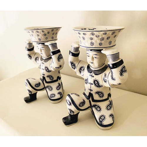 411 - TRINKET DISHES, a pair, in the form of Chinese soldiers holding a basket aloft, 33cm H (2)