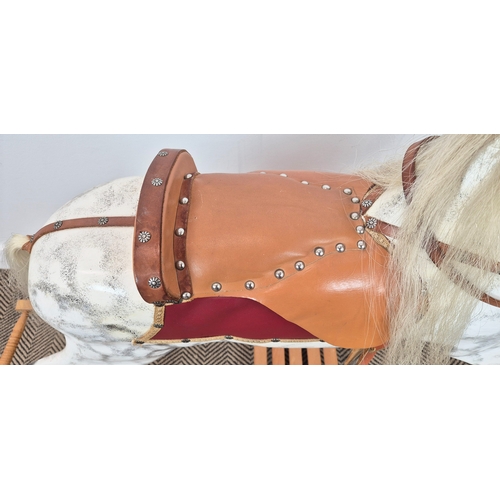 228 - A VICTORIAN STYLE DAPPLED ROCKING HORSE, leather embellishments, horsehair tail and mane, 105cm H x ... 