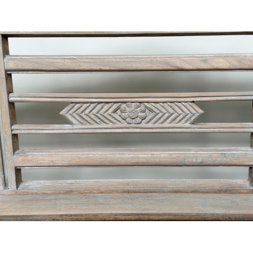 493 - GARDEN BENCH, vintage colonial style faded teak, 133cm W.