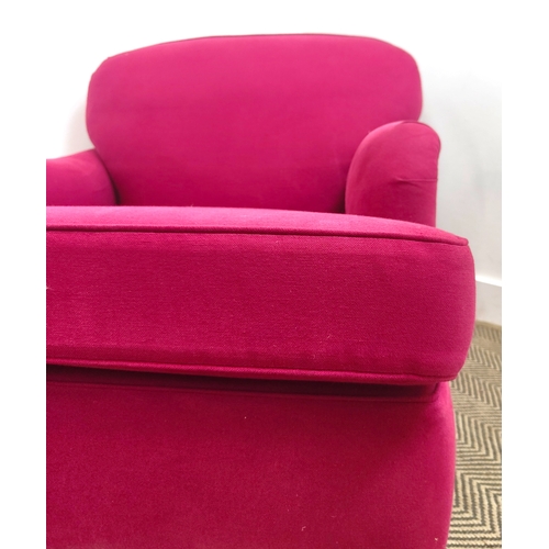 151 - HOWARD STYLE ARMCHAIRS, a pair, magenta fabric upholstered on brass castors, 77cm H x 85cm W 110cm D... 