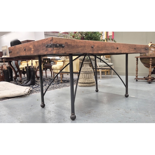 208 - DINING TABLE, Indian teak and metal studded with glazed panel door top on metal base, 79cm H x 171cm... 