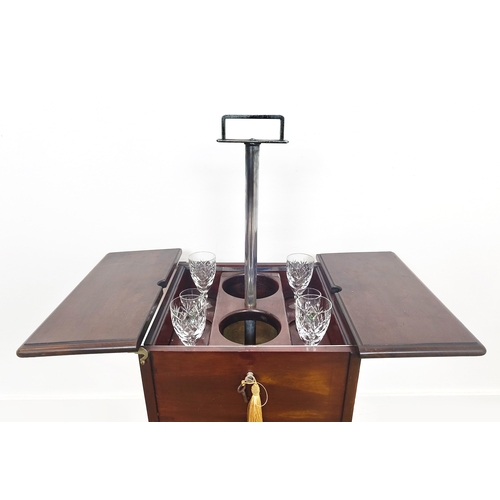 21 - AN EARLY 20TH CENTURY MAHOGANY ELEVETTE, enclosing glass and decanter spaces, plus various glassware... 