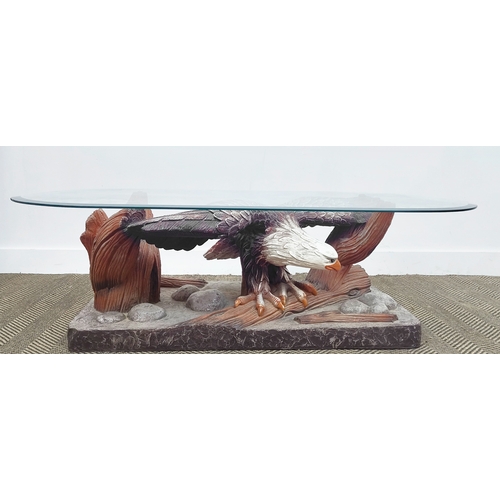 361 - LOW TABLE, shaped bevelled glass top on polychrome resin eagle support, 42cm H x 135cm W x 66cm D.