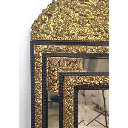 395 - LATE 19TH CENTURY DUTCH MIRROR, with repoussé brass decoration, bevelled design, ebonised wooden mou... 