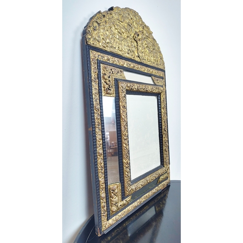 395 - LATE 19TH CENTURY DUTCH MIRROR, with repoussé brass decoration, bevelled design, ebonised wooden mou... 