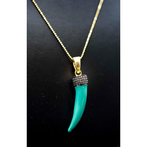 38 - A TURQUOISE ENAMEL TIGER TOOTH PENDANT SET to the top with old rose cut diamonds, in yellow metal on... 