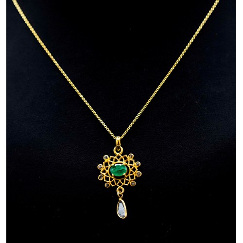 39 - FLORAL PENDANT IN YELLOW METAL SET WITH AN OVAL EMERALD, DIAMONDS AND SLICE DIAMONDS ON A GOLD PLATE... 