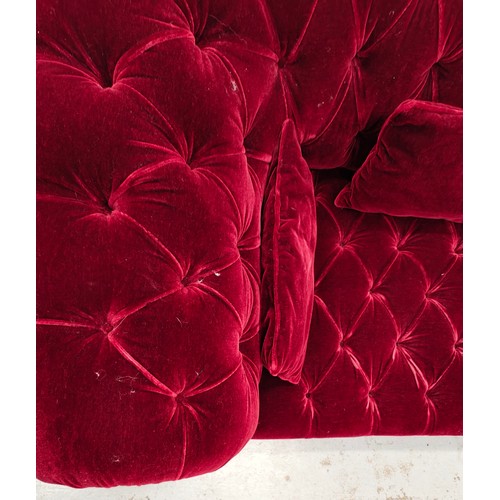 285 - GEORGE SMITH CHESTERFIELD SOFA, in claret buttoned plush upholstery with studded detail, bears plaqu... 