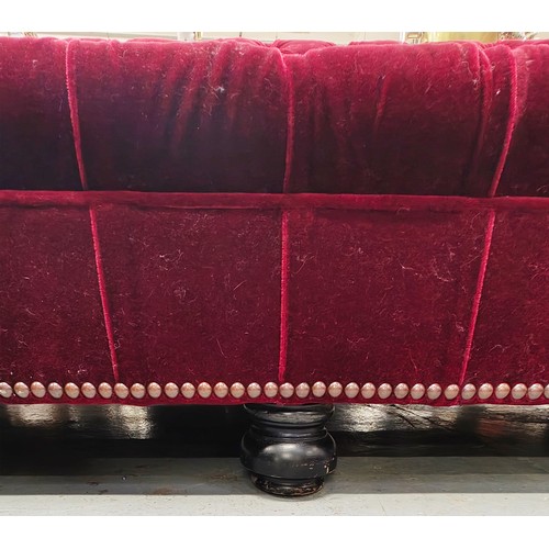 285 - GEORGE SMITH CHESTERFIELD SOFA, in claret buttoned plush upholstery with studded detail, bears plaqu... 