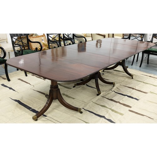 412 - TRIPLE PEDESTAL DINING TABLE, Regency style mahogany with two extra leaves, brass clips and castors,... 