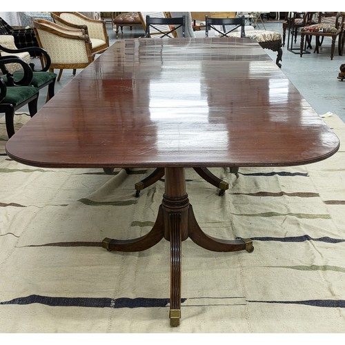 412 - TRIPLE PEDESTAL DINING TABLE, Regency style mahogany with two extra leaves, brass clips and castors,... 