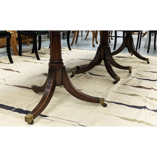 412 - TRIPLE PEDESTAL DINING TABLE, Regency style mahogany with two extra leaves, brass clips and castors,... 