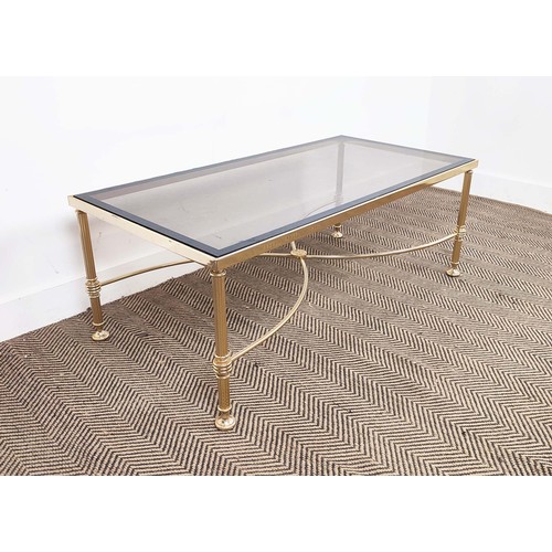 282 - HOLLYWOOD REGENCY MANNER LOW TABLE, brass with rectangular tinted glass top, 42cm H x 112cm W x 57cm... 