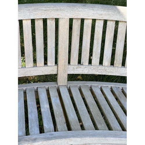 521 - BANANA GARDEN BENCH, well weathered teak of slatted construction with rounded back and arms, 158cm W... 