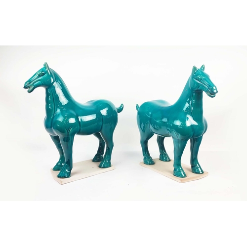 1 - TANG STYLE POTTERY HORSES, a pair, with a turquoise glaze, 50cm L x 51cm H. (2)