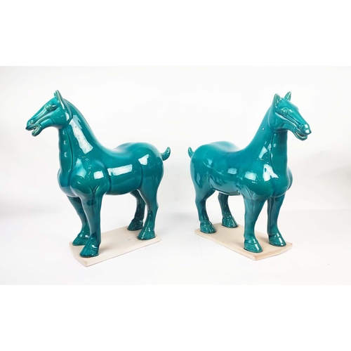 1 - TANG STYLE POTTERY HORSES, a pair, with a turquoise glaze, 50cm L x 51cm H. (2)