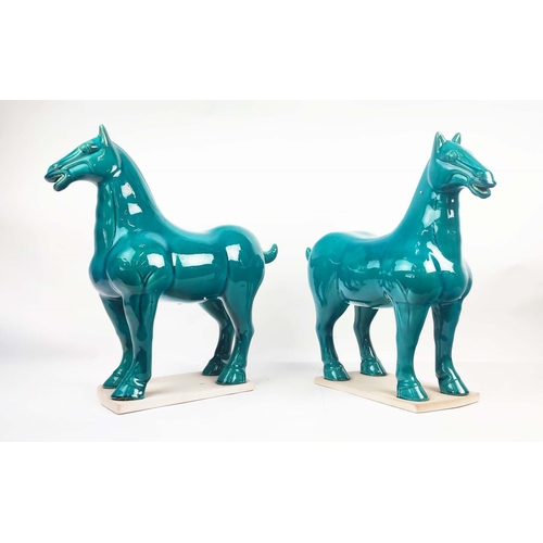 1 - TANG STYLE POTTERY HORSES, a pair, with a turquoise glaze, 50cm L x 51cm H. (2)