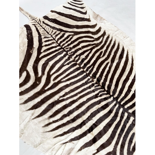 134 - ZEBRA SKIN RUG, early 20th century, 300cm x 160cm.