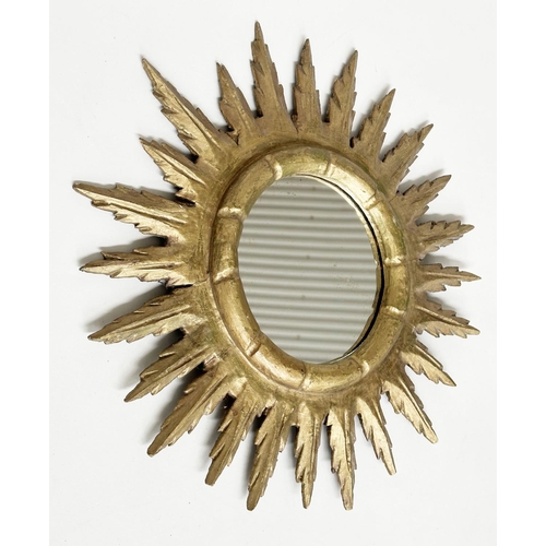 136 - STARBURST WALL MIRROR, carved giltwood with circular mirror and stellar frame, 50cm W.