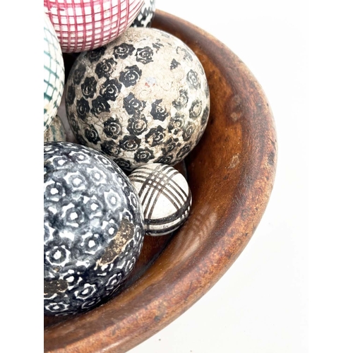 149 - CARPET BOWLS, twelve Victorian period ceramic in wooden bowl. (12)