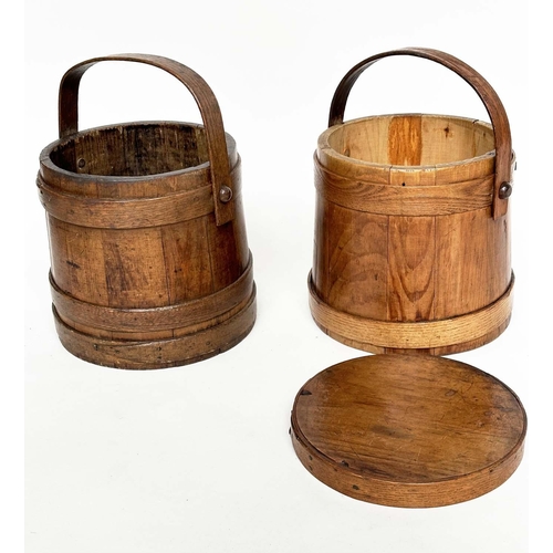 155 - RICE BUCKETS, two antique earthen varnished fir, tapering with handles, one lidded, 26cm W. (2)