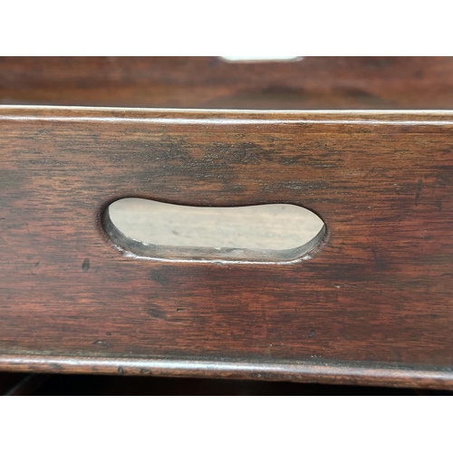 162 - GEORGIAN BUTLER TRAYS, four Georgian mahogany, each galleried with pierced handles, largest 67cm x 4... 