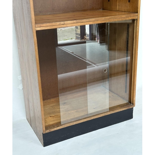 163 - DISPLAY CASE/BOOKCASE, mid 20th century oak with two adjustable glass shelves above a two sliding do... 