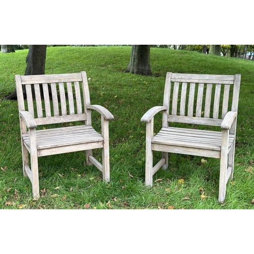 164 - GARDEN ARMCHAIRS, a pair, well weathered teak of slatted construction with curved arms, 68cm W. (2)