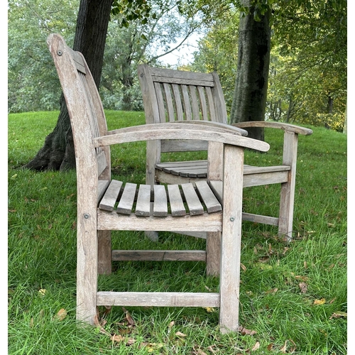 164 - GARDEN ARMCHAIRS, a pair, well weathered teak of slatted construction with curved arms, 68cm W. (2)