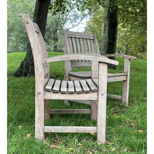 164 - GARDEN ARMCHAIRS, a pair, well weathered teak of slatted construction with curved arms, 68cm W. (2)