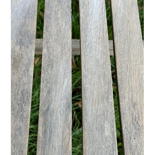 164 - GARDEN ARMCHAIRS, a pair, well weathered teak of slatted construction with curved arms, 68cm W. (2)