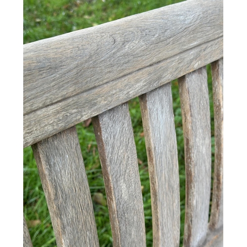 164 - GARDEN ARMCHAIRS, a pair, well weathered teak of slatted construction with curved arms, 68cm W. (2)