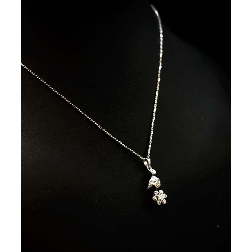 41 - 14CT WHITE GOLD DROPLET FLOWER NECKLACE, set with RBC and R/C diamonds, boxed. Diamonds 0.58ct appro... 