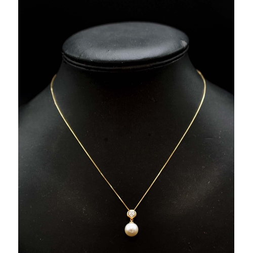 42 - 9CT YELLOW GOLD CULTURED PEARL AND DIAMOND BALE PENDANT, with 9ct yellow gold box link chain, boxed.... 