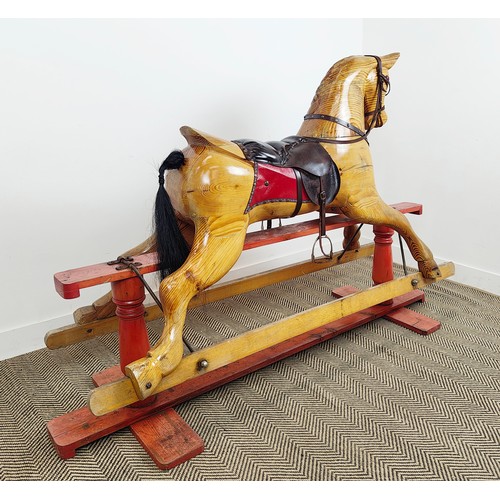 253 - ROCKING HORSE, vintage pine and leather on painted base, 126cm H x 183cm L x 56cm W.