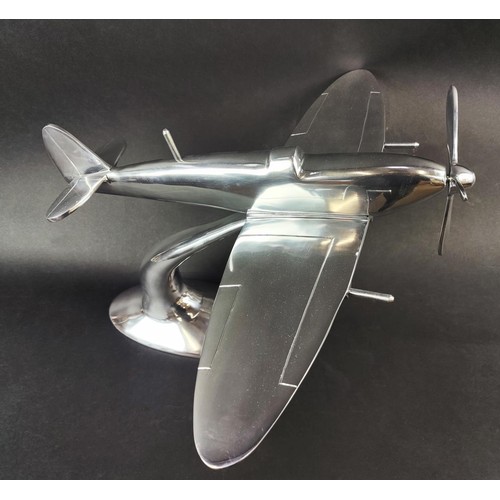 445 - SPITFIRE ORNAMENT, polished metal, on stand, 35cm H x 60cm x 50cm.