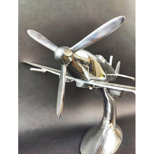 445 - SPITFIRE ORNAMENT, polished metal, on stand, 35cm H x 60cm x 50cm.