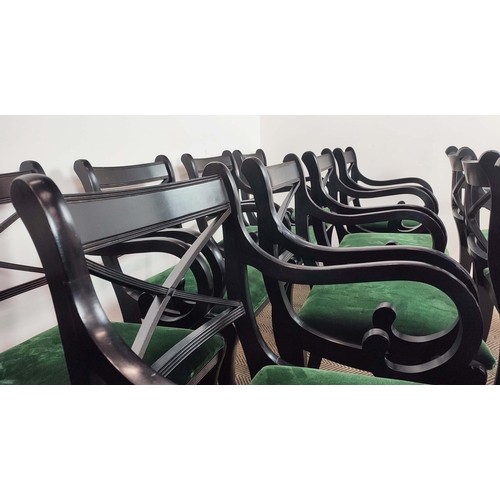 167 - DINING CHAIRS, a set of fourteen Regency style, ebonised with scroll arms and green velvet drop in s... 