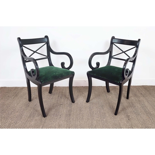 167 - DINING CHAIRS, a set of fourteen Regency style, ebonised with scroll arms and green velvet drop in s... 