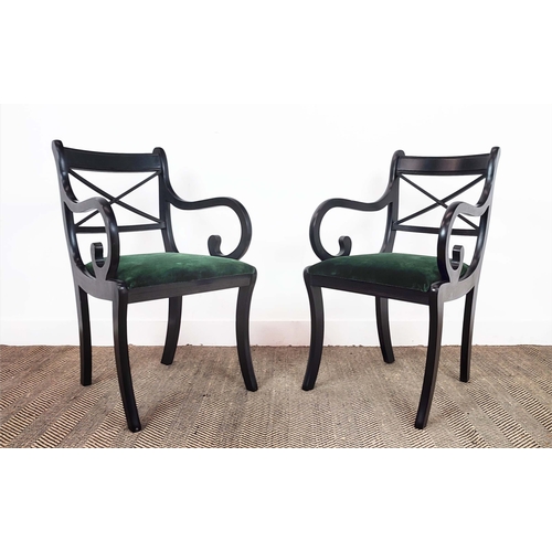 167 - DINING CHAIRS, a set of fourteen Regency style, ebonised with scroll arms and green velvet drop in s... 