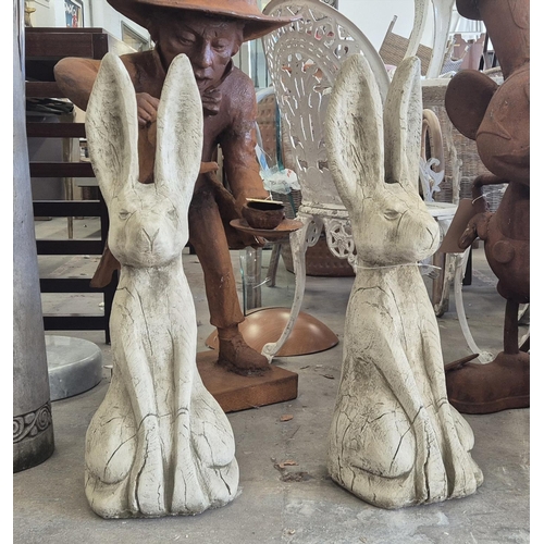 448 - SCULPTURAL HARES, a pair, composite stone, 68cm H approx.