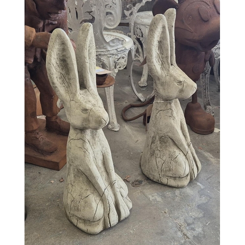 448 - SCULPTURAL HARES, a pair, composite stone, 68cm H approx.