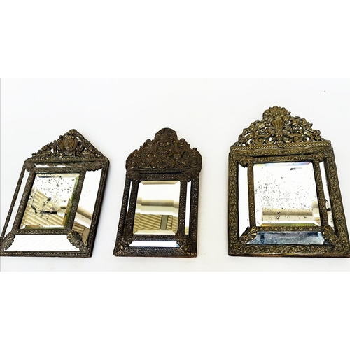 109 - WALL MIRRORS, a near pair, late/early 20th century Dutch style repoussé silvered, each with cushion ... 